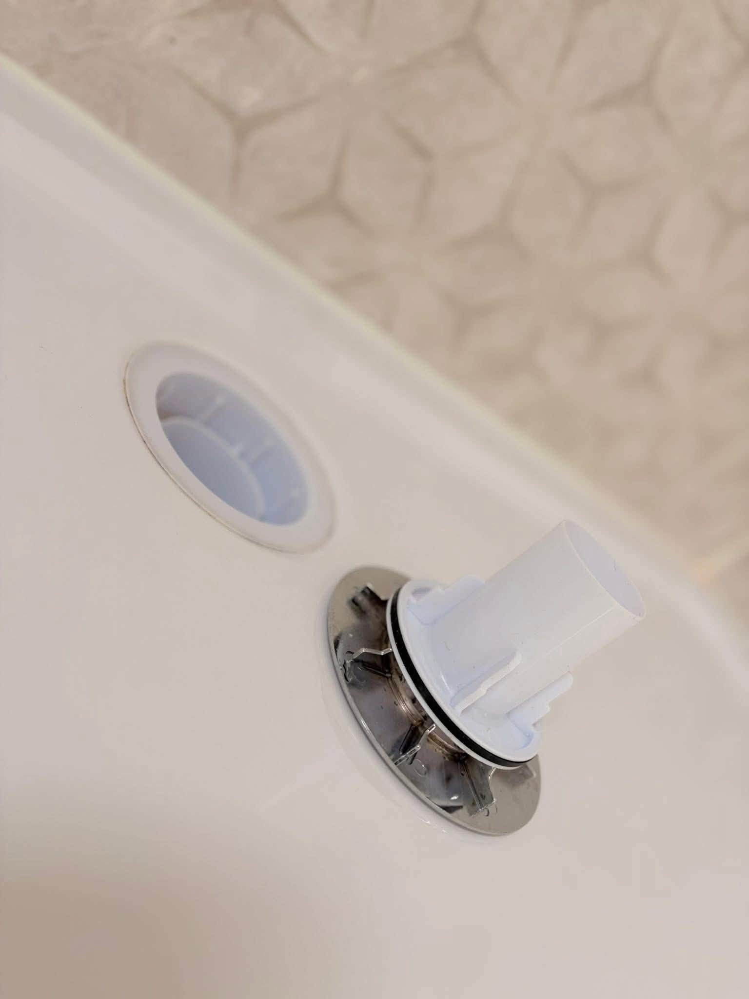 The same bath drain fitting after cleaning, bright and clear