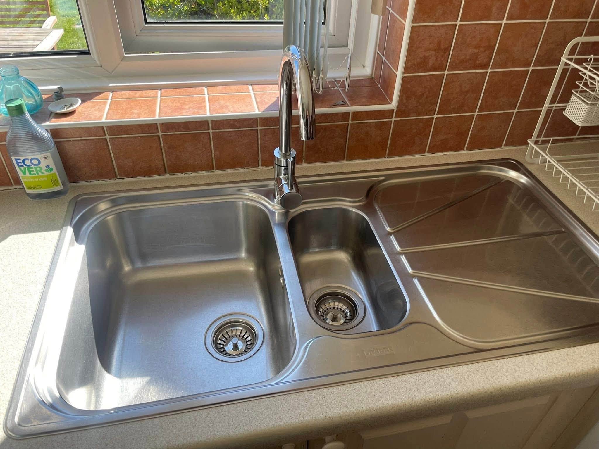 A spotless, polished kitchen sink