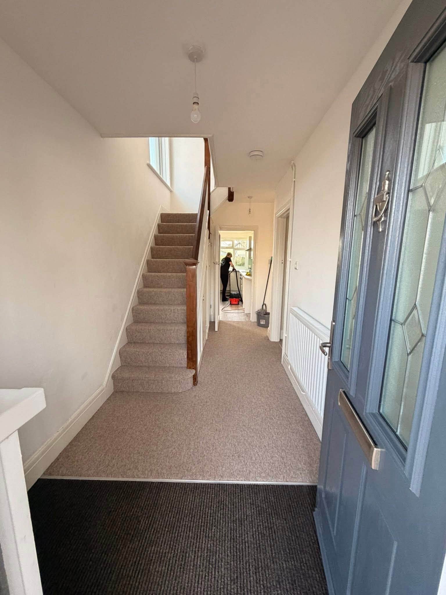 A Sparkle & Sweep cleaner at work in a client's home